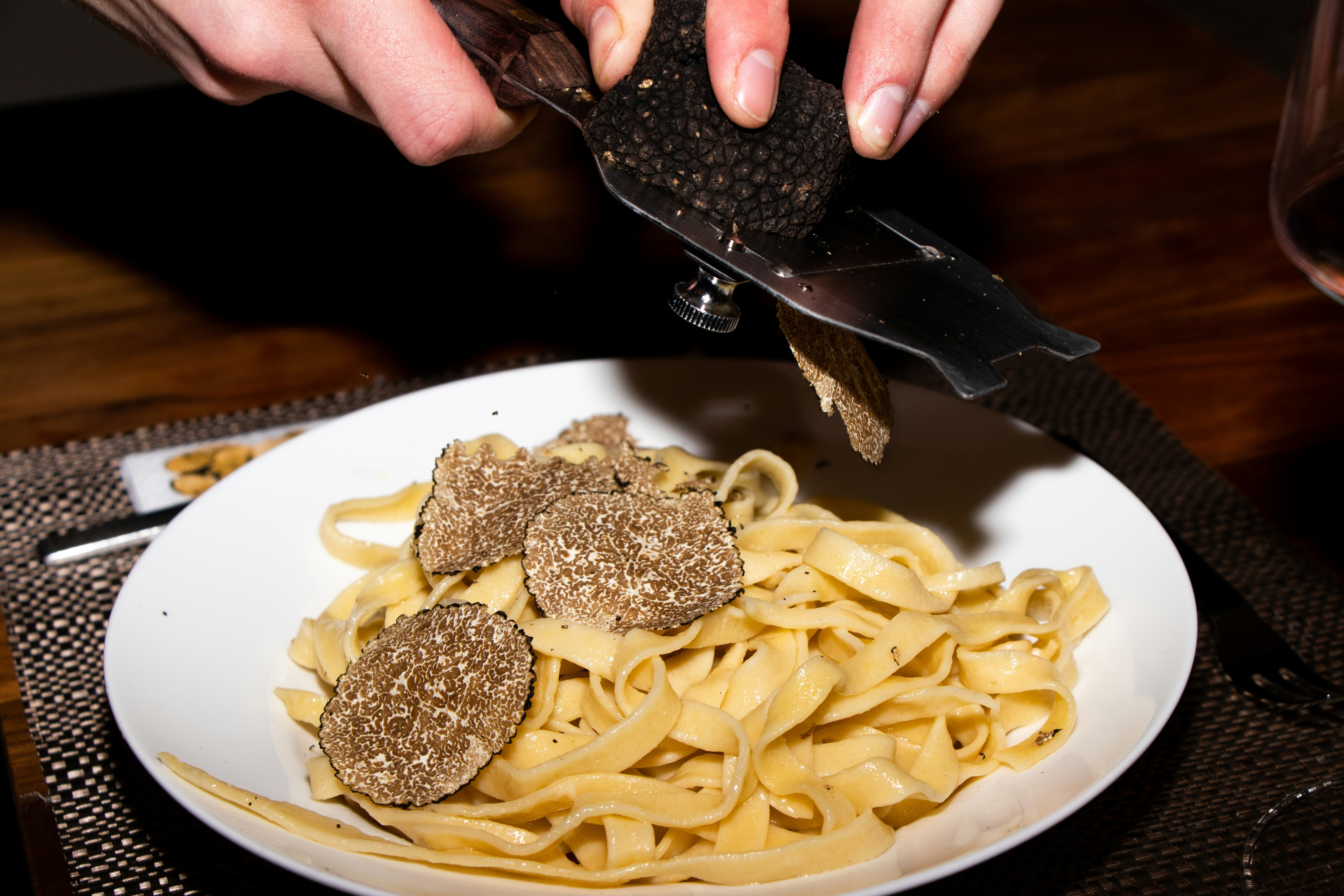 a plate of pasta with meatballs and a knife